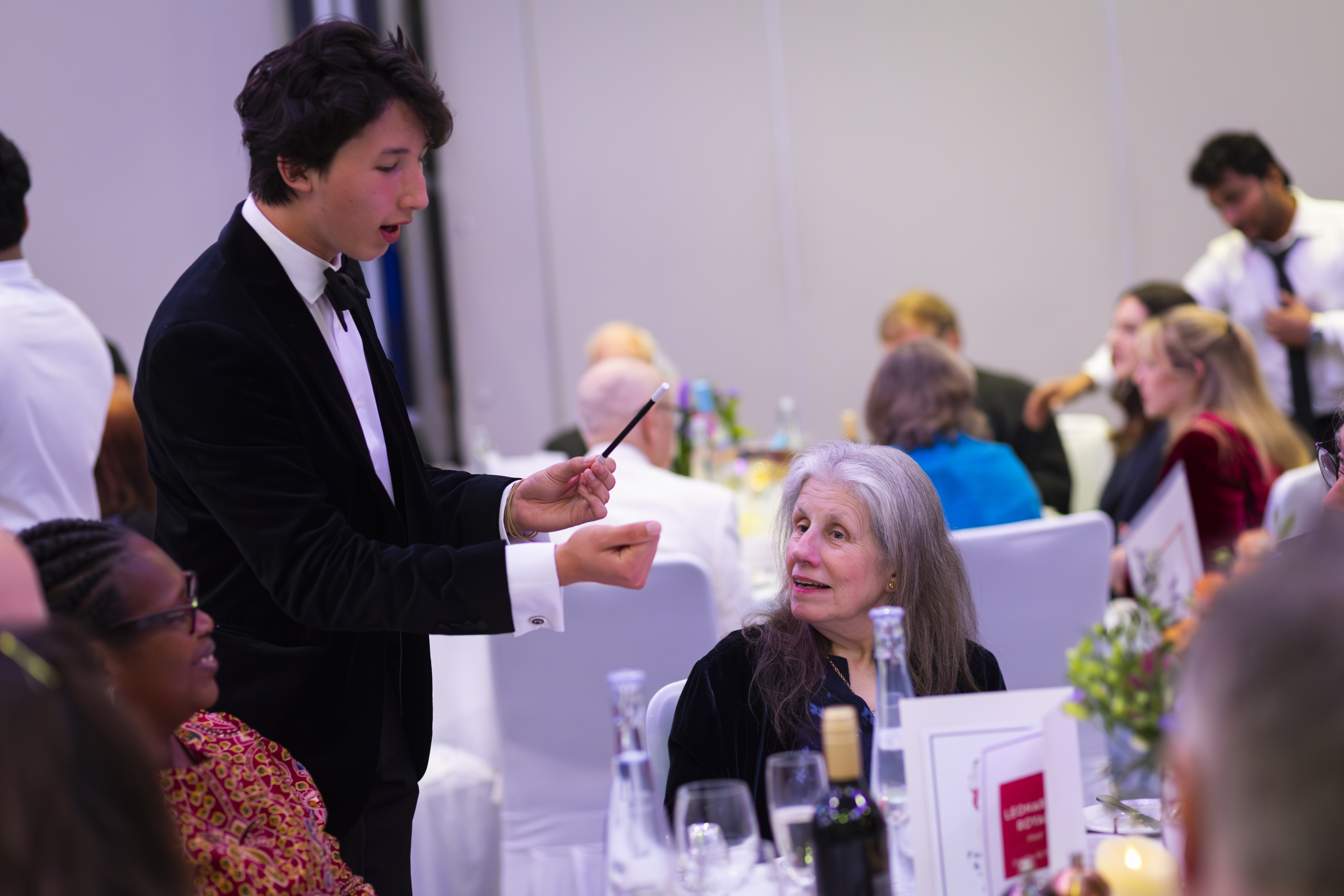 Noah performing magic for a group